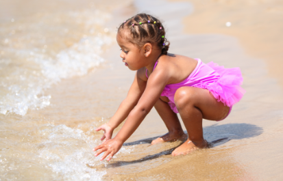 girl playing in safe beach water