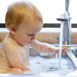 baby bathing in clean home water
